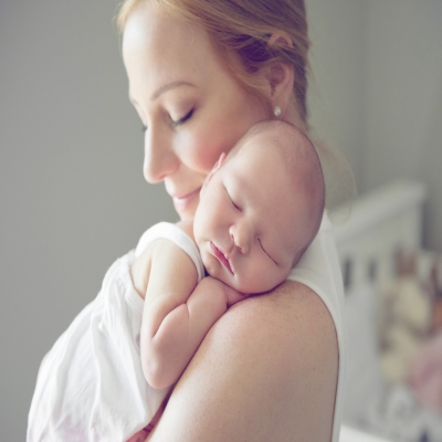 Woman holding sleeping baby