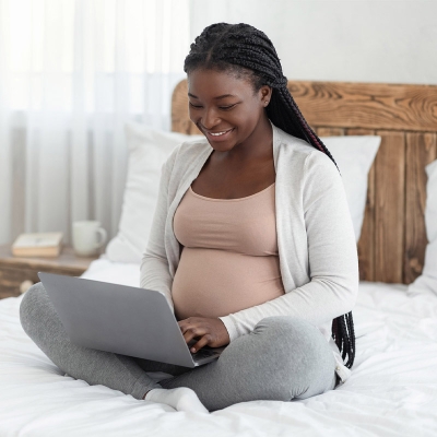 Pregnant Woman using a laptop