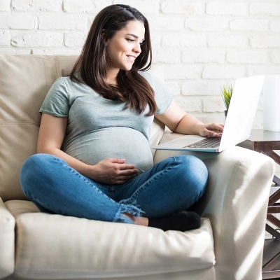 Expectant Mother using a laptop